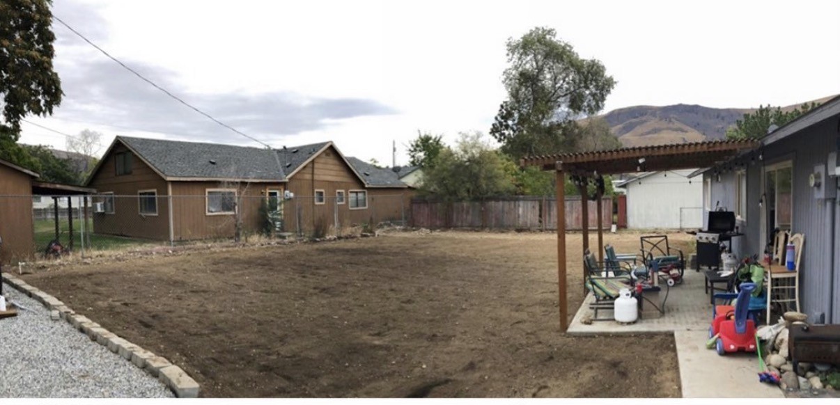 Bare dirt backyard graded and prepped before new sod installation