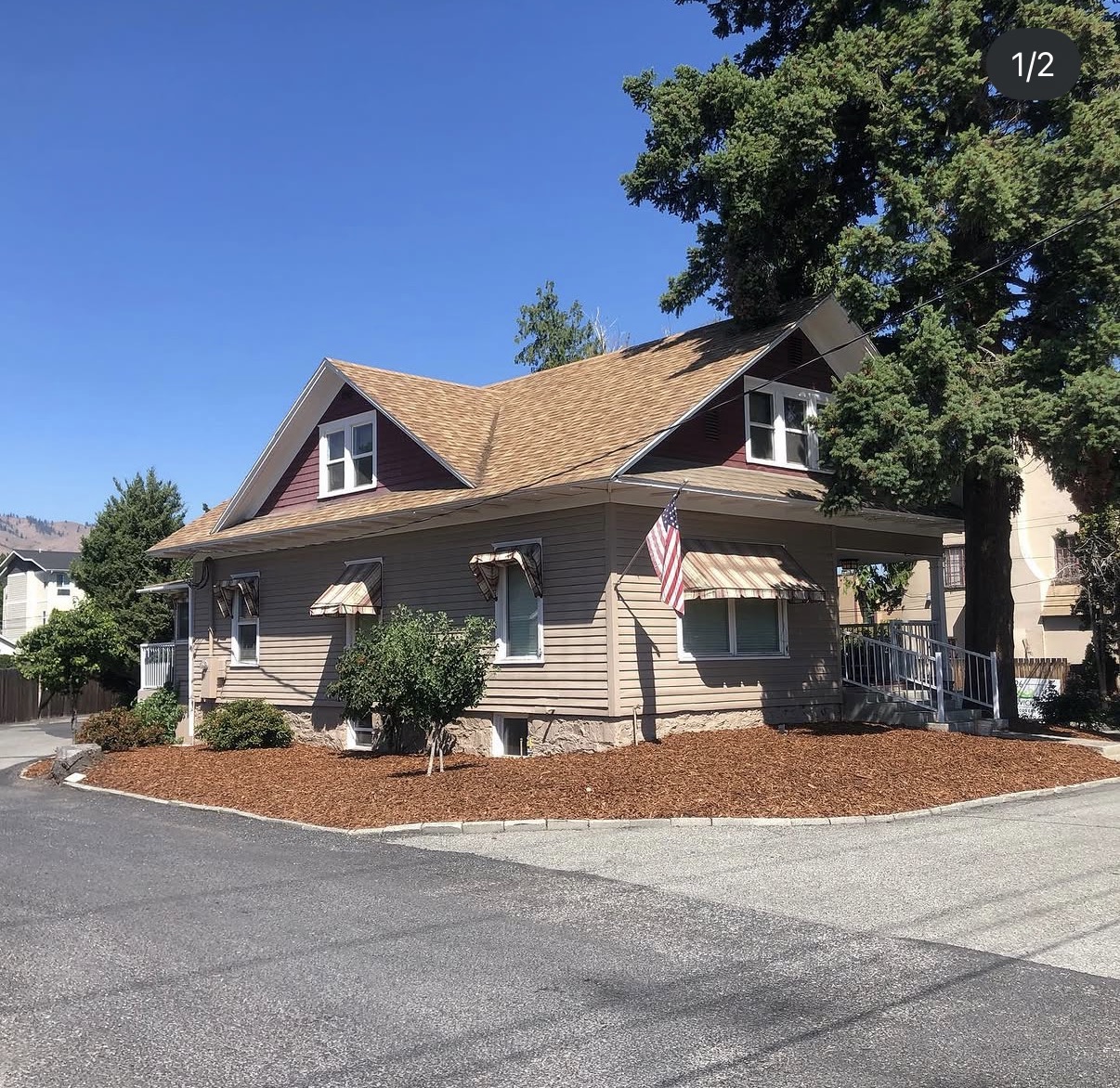 Fresh bark mulch beds installed around a craftsman home
